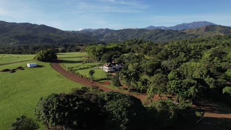 aerial circling farmhouse, revealing rural landscape on sunny day, dominican republic