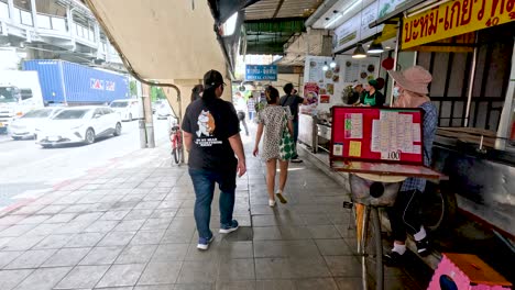 people walking past shops and street vendors