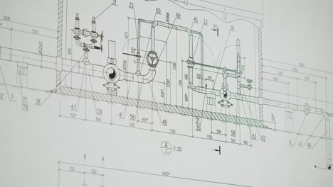 hand pointing at details on an engineering blueprint