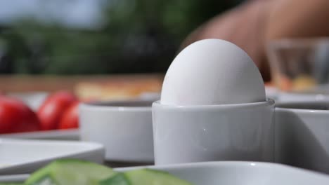 close-up of a boiled egg in an egg cup on a breakfast table