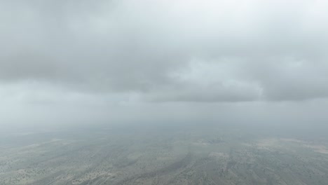 Aerial-drone-tilt-down-shot-over-a-tiny-village-in-Tharparkar,-Sindh,-Pakistan-on-a-cloudy-day