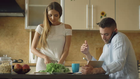 couple cooking and working at home