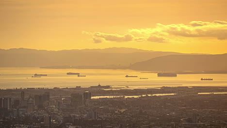 Wonderful-warm-sunset-over-coastal-city-in-United-States,-shipshape-on-the-horizon-at-dusk