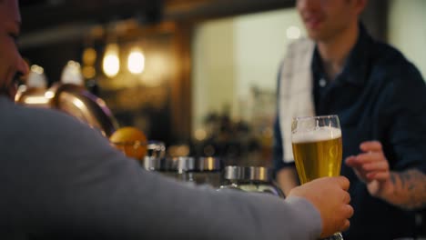 busy male bartender beer at bar to the clients