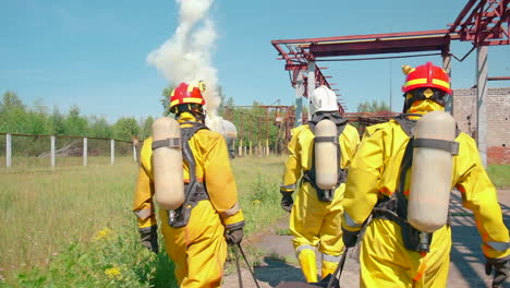 firefighters responding to a fire at an industrial site