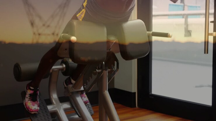 Woman starting on bench doing repeated back raises by gym window, overlaying tower, toning core
