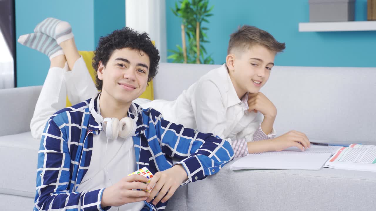 Two brothers looking at camera and smiling.