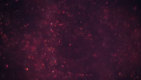 un caótico y suave remolino de burbujas rojas brillantes y transparentes como moléculas en el fondo oscuro del cosmos.