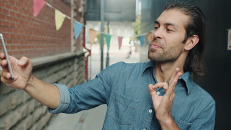 man taking selfie in urban alleyway