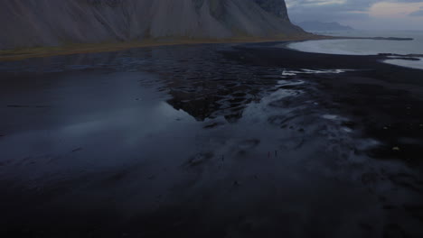 aerial: reveal shot of stokksnes in iceland during dusk