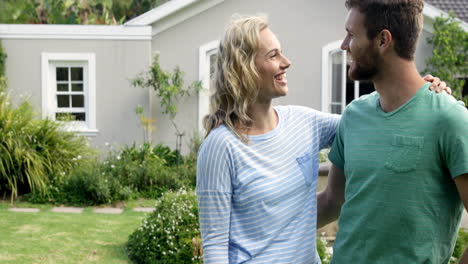 young lovely couple with their house