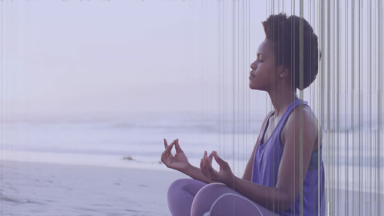 Meditating on beach, person with colorful animation lines overlaying scene