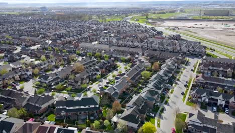 Flying-around-Milton-houses-next-to-farmers-fields-on-a-sunny-morning