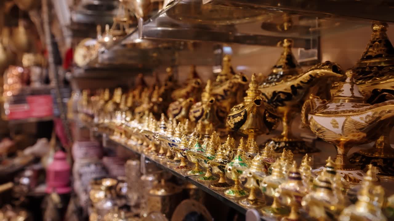 Golden decorative lamps and ornaments neatly displayed inside a traditional Moroccan market
