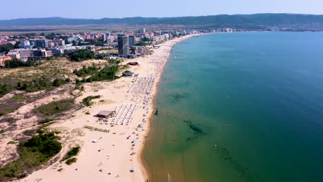 4k moving forward drone clip over an exotic golden sand beach in sunny beach, bulgaria