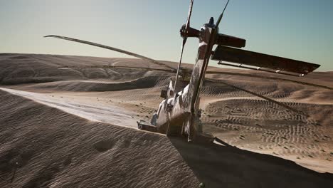 old rusted military helicopter in the desert at sunset