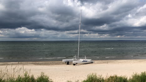 catamaran boat resting on the beach