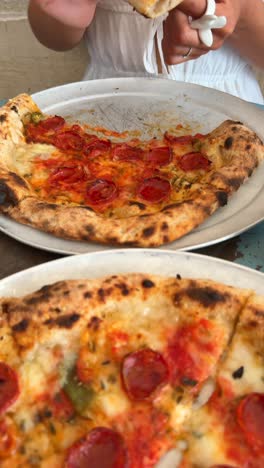 enjoying delicious pepperoni pizza