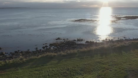 bright sunset at calm coast bay of iceland peninsula, aerial