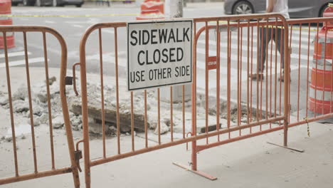 slow motion wide of a closed sidewalk and work site in nyc