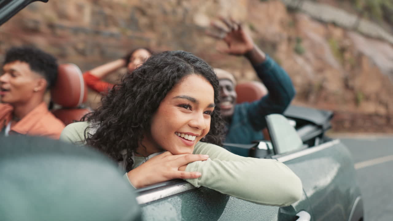 Group of friends enjoying a convertible road trip