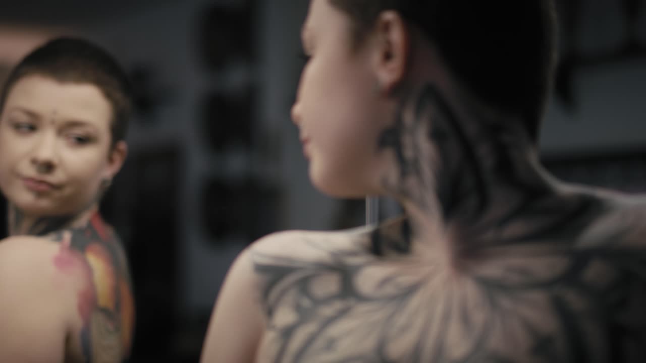 Young adult caucasian woman looking at herself in the mirror.