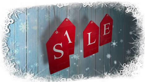 red sale tags hanging against wood with festive border