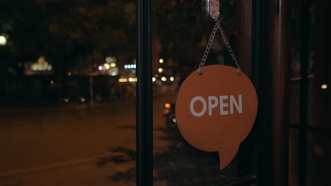 Changing-store-door-sign-from-Open-to-Close-at-night