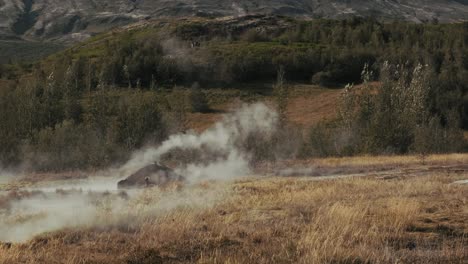 Hot-steam-rising-from-small-smidur-Geysir-boiling-geothermal-hot-spring-water-boiling-on-golden-circle,-strokkur-Iceland