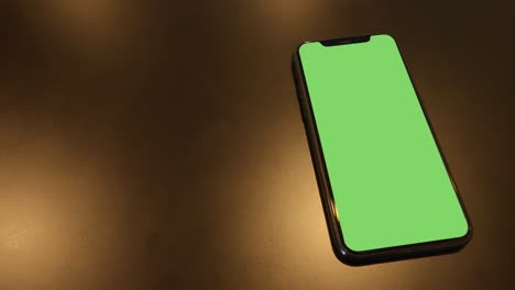 smartphone place on black background with gold light