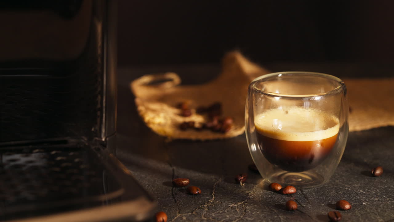 Cup Of Espresso With Coffee Beans on The Table. - closeup shot