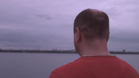 man looking out at a lake