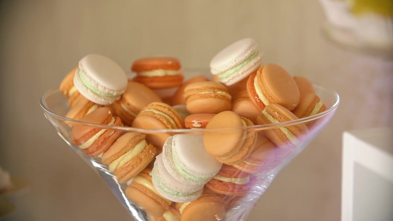 Colorful Macarons in a Glass Bowl on a Dessert Table