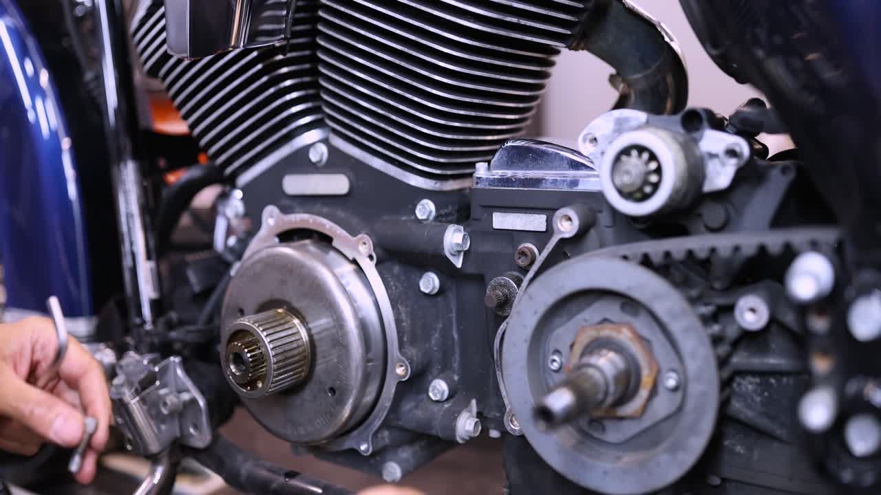Mechanic using wrench and socket on motorcycle cylinder head 4k movie