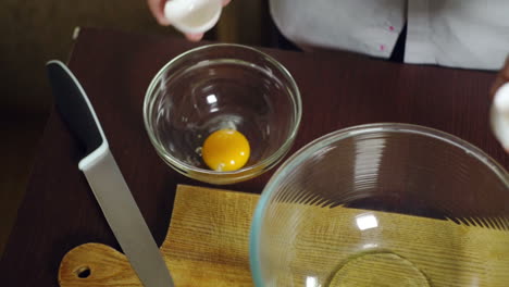 egg falling in glass bowl. preparing ingredients for baking cake. cooking food