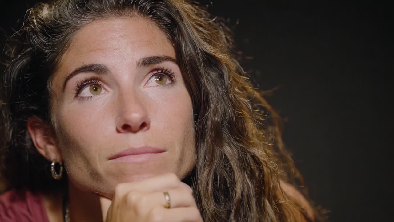 Contemplative Reflection: Capturing a Moment of Thoughtfulness and Introspection in a Portrait of a Thoughtful Individual with Curly Hair