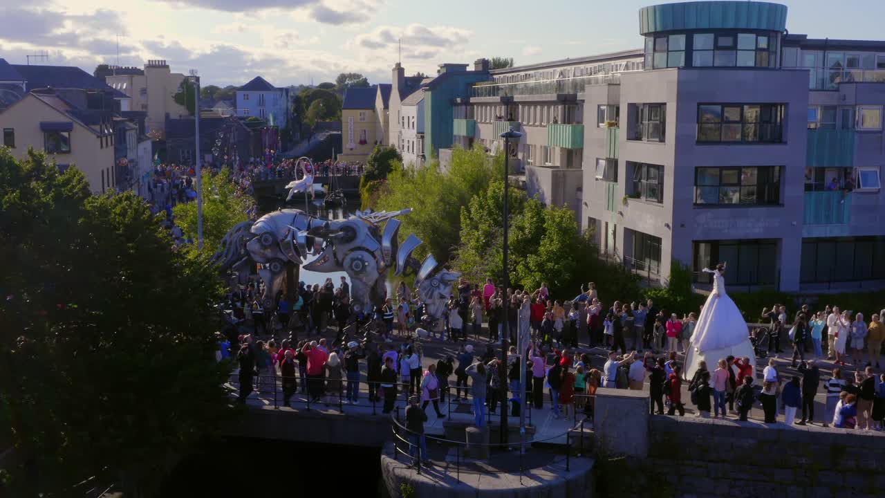 Aerial View of a City Parade with Large Metal Sculptures