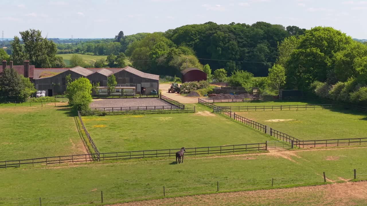 A stunning orbit and panoramic drone view of a UK farm, showcasing green fields, rustic barns, and the beauty of the rural countryside
