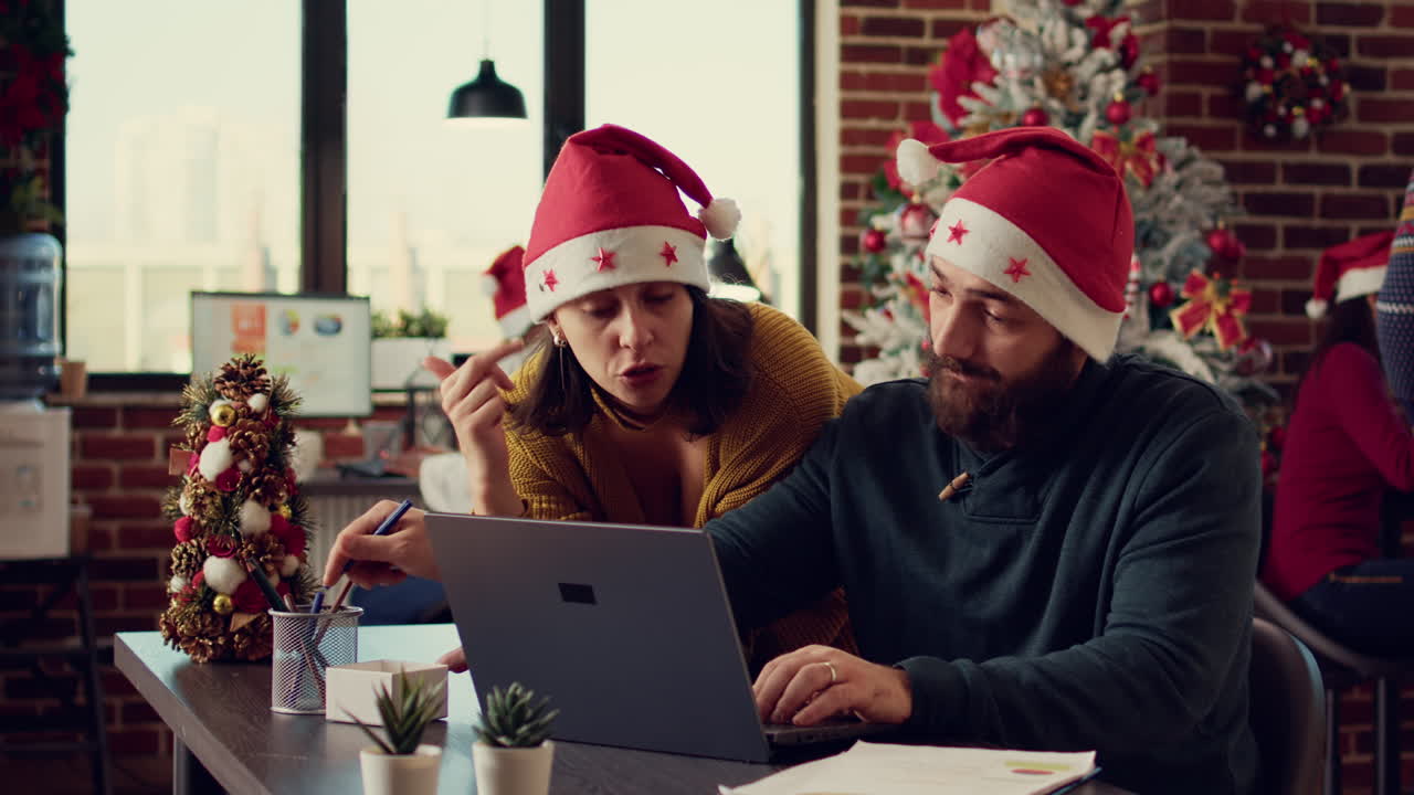 Office coworkers working on report in festive decorated space