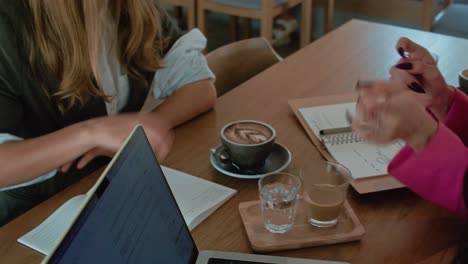 businesswomen in a coffee shop meeting