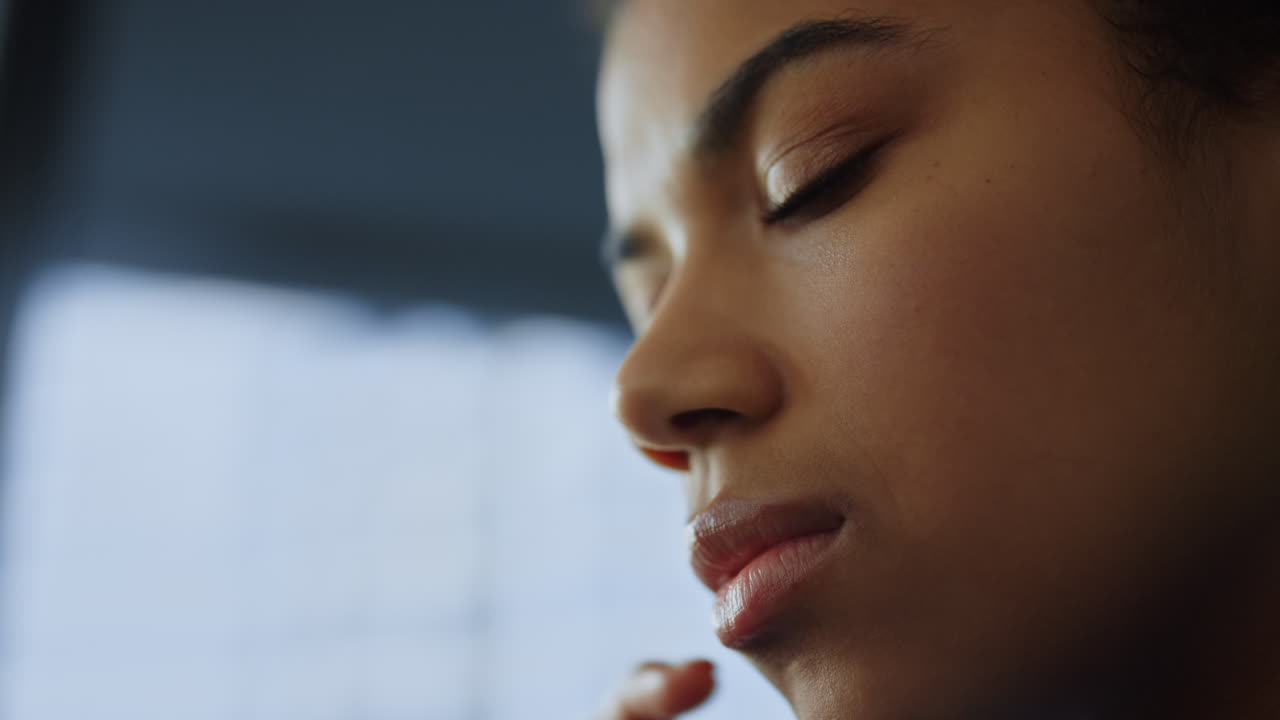 Businesswoman posing in office. Female professional face looking down