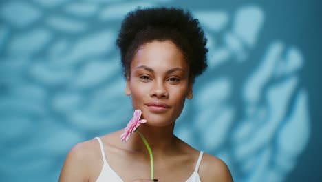 smiling woman with pink flower