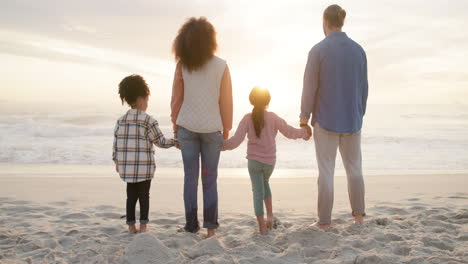 family, holding hands and children on beach