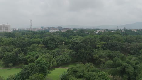 aerial - forested area under a cloudy sky, abuja, nigeria, reverse