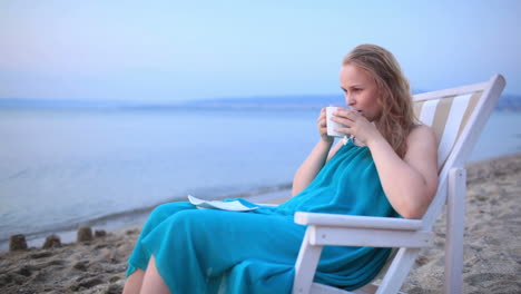 woman enjoying a cup of tea at the seaside