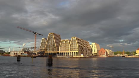 view of new construction developments in copenhagen waterfront at sunset