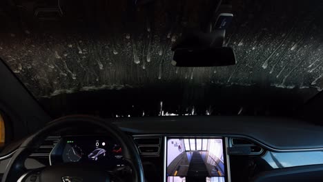 slow motion of a tesla model x being washed in the car wash