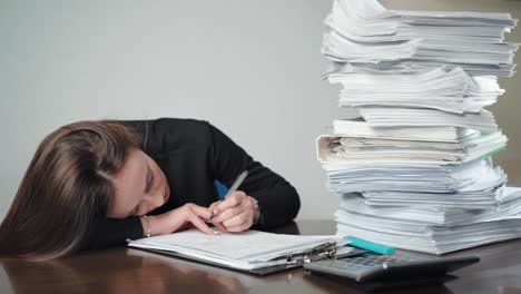 a pile of unfinished documents and files and sad businesswoman doing calculations and making notes in the office. management work, finance accounting and deadline concept. overloaded office worker with a pile of paperwork