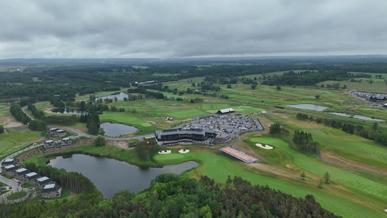 Drone of TPC Toronto fairways and water hazards under bright summer sky