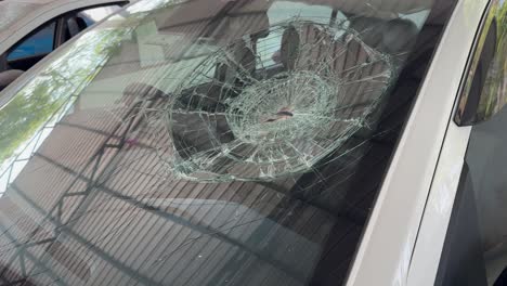bullet holes on the windshield of car, bullet holes. smash car windshield, broken and damaged car